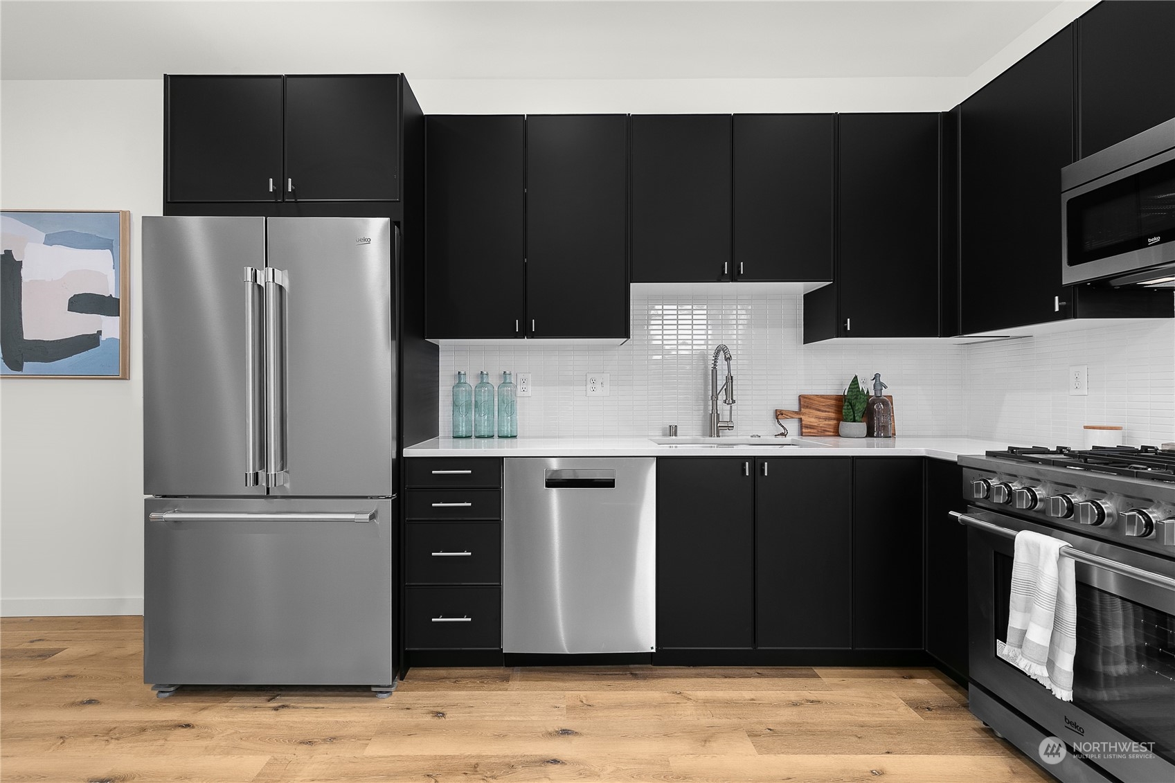 9429 18th Avenue Southwest, Unit B Seattle, WA 98106 - Photo 13 of 28 a kitchen with a refrigerator and cabinets