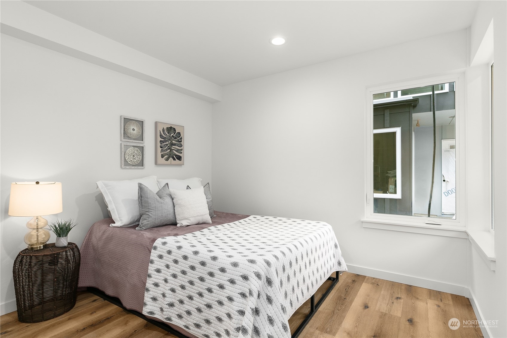 9429 18th Avenue Southwest, Unit B Seattle, WA 98106 - Photo 18 of 28 a bedroom with a bed and a window