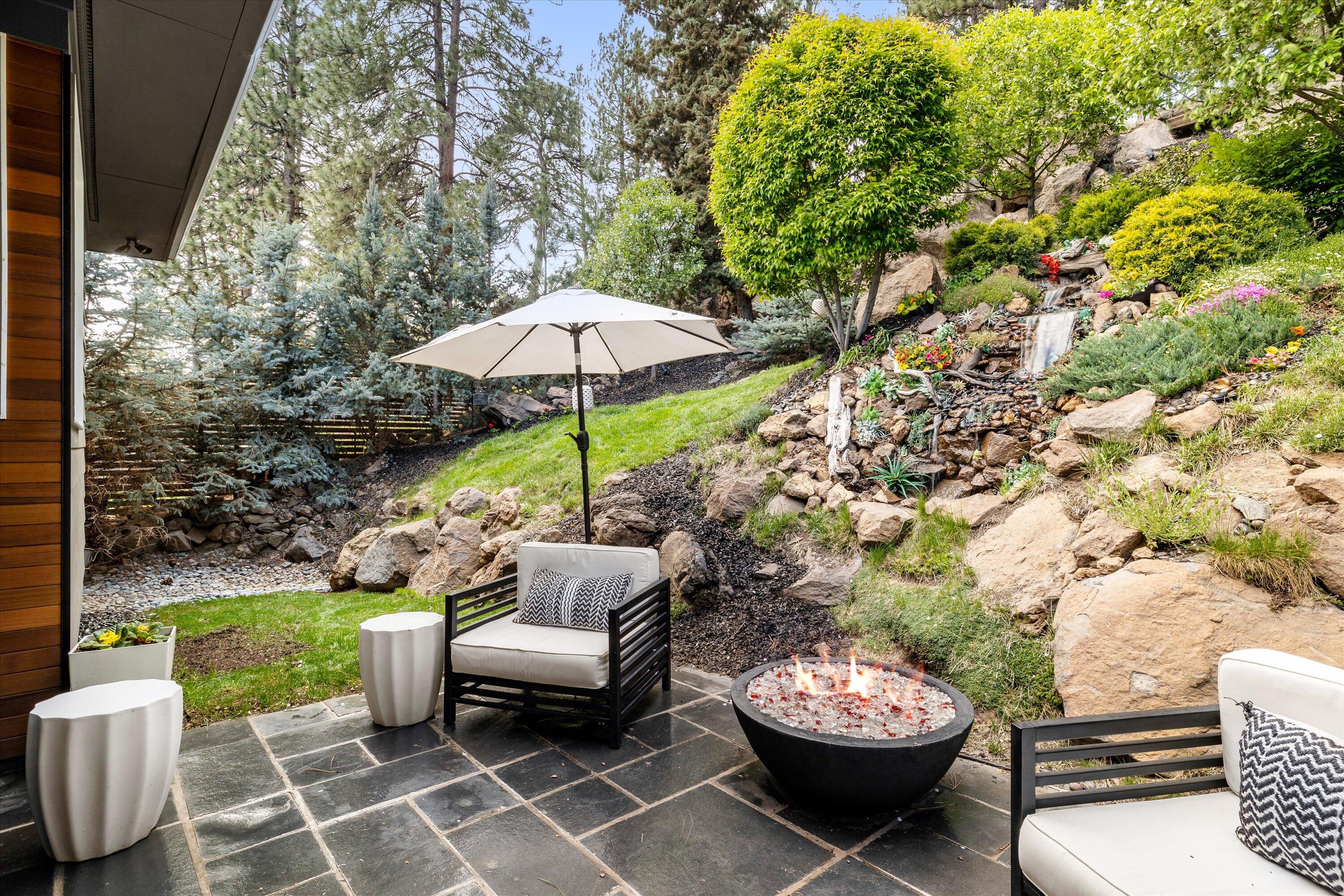 19504 Southwest Century Drive Bend, OR 97702 - Photo 40 of 58 a view of a patio with a table and chairs under an umbrella