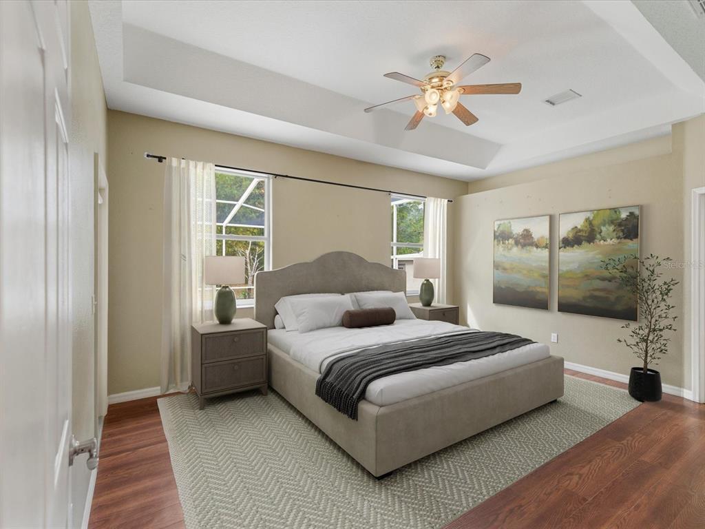 8551 Pratt Drive New Port Richey, FL 34654 - Photo 12 of 100 a bedroom with a large bed and a chandelier