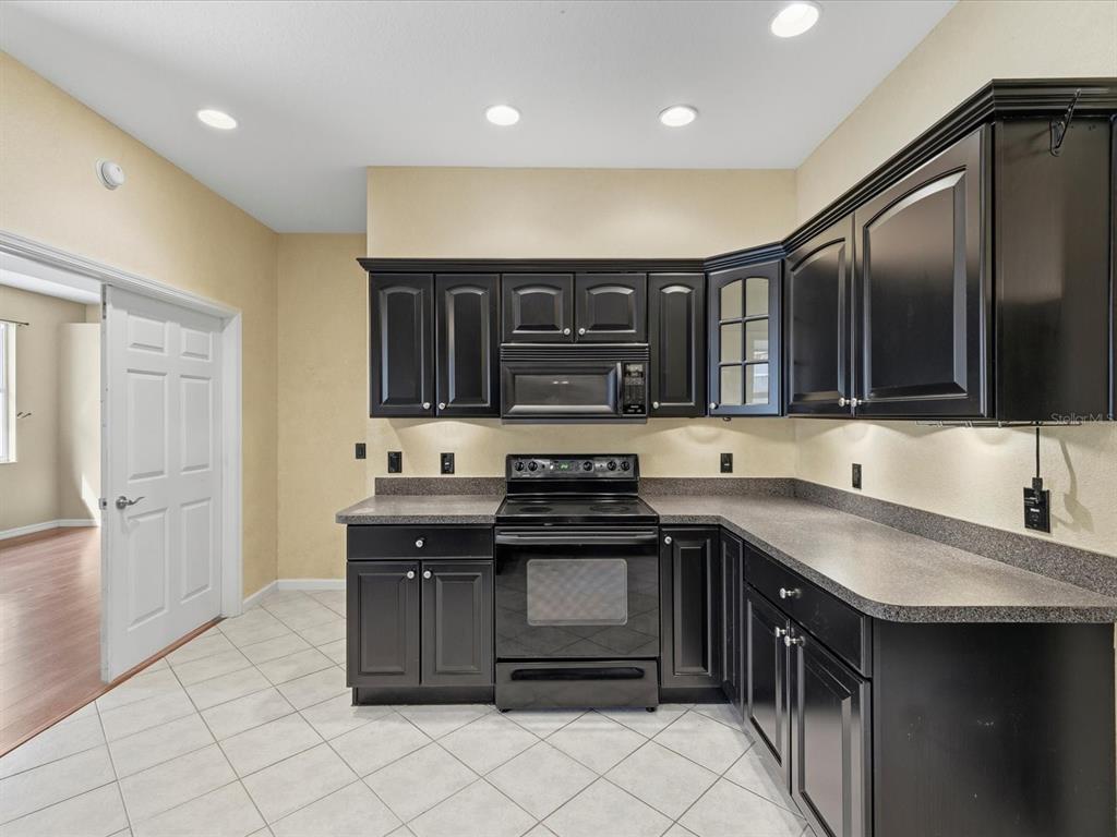 8551 Pratt Drive New Port Richey, FL 34654 - Photo 20 of 100 a kitchen with stainless steel appliances granite countertop a stove and a sink