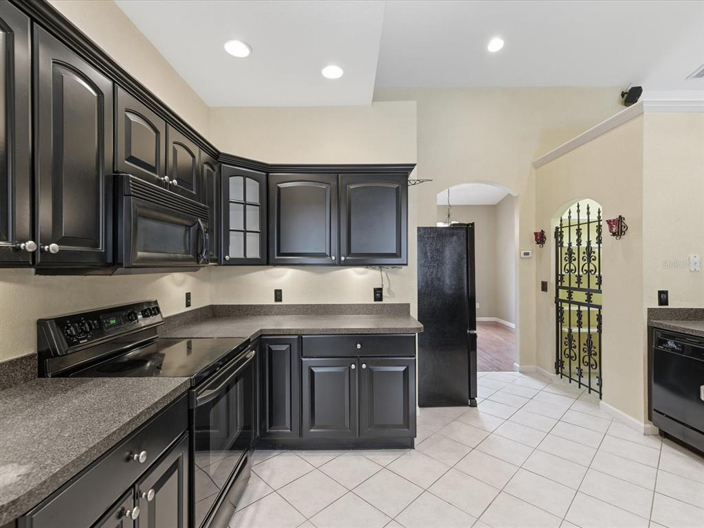 8551 Pratt Drive New Port Richey, FL 34654 - Photo 21 of 100 a kitchen with stainless steel appliances granite countertop a stove a sink and a refrigerator