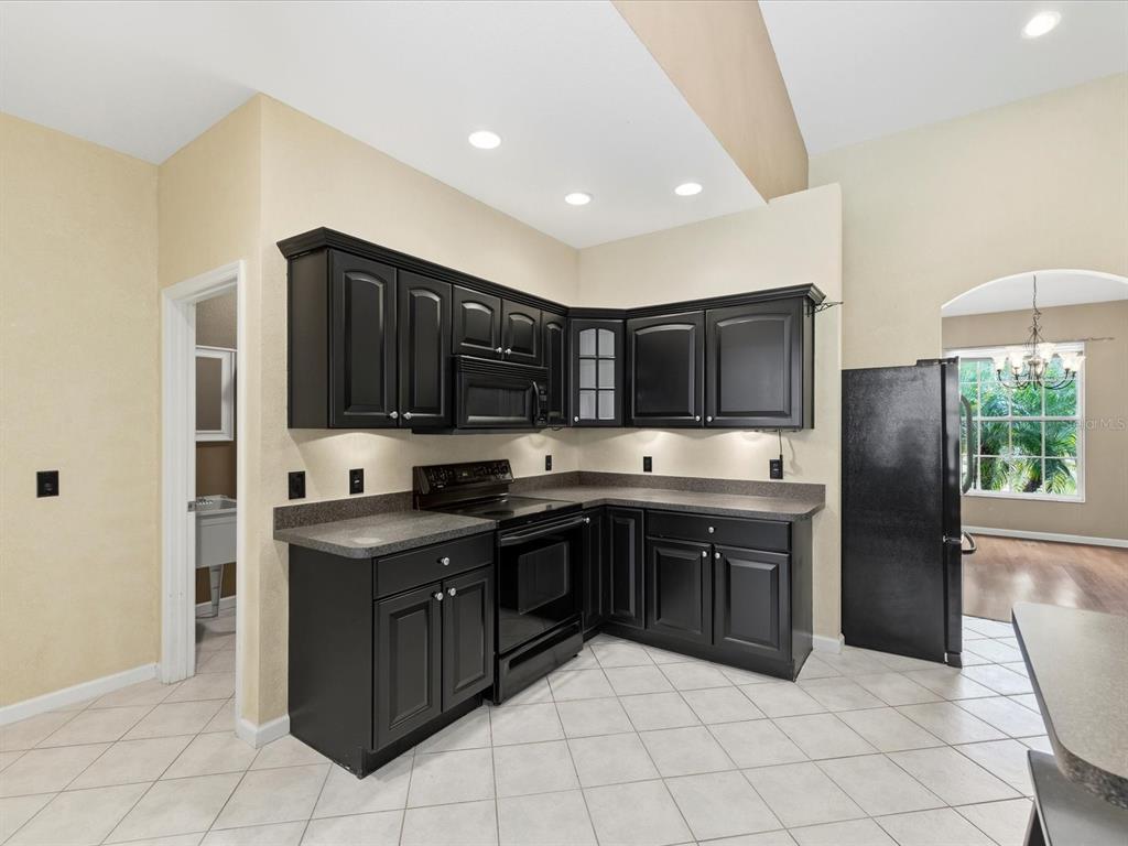 8551 Pratt Drive New Port Richey, FL 34654 - Photo 23 of 100 a kitchen with stainless steel appliances granite countertop a sink and a refrigerator