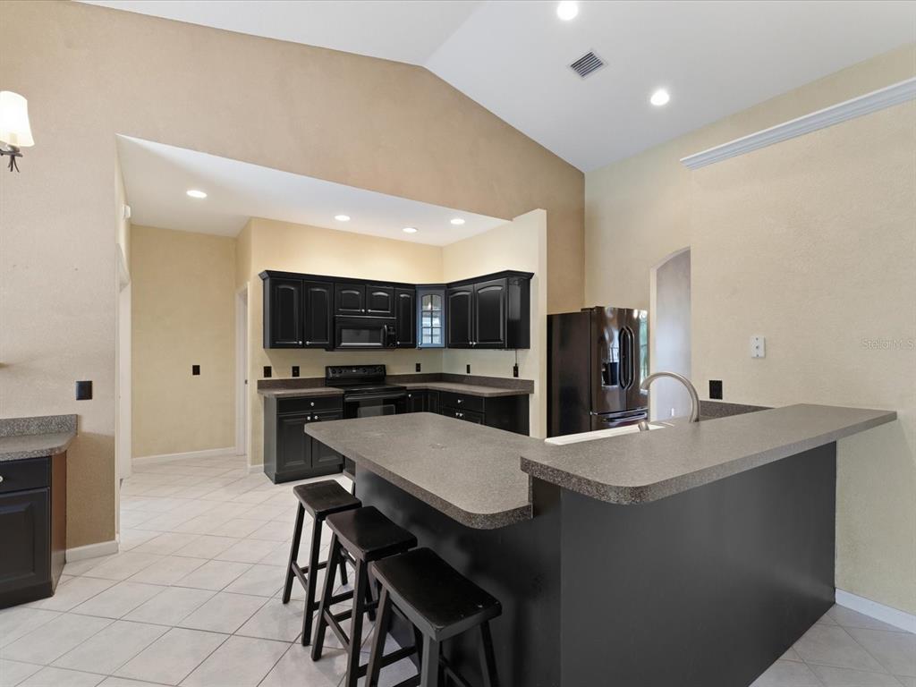 8551 Pratt Drive New Port Richey, FL 34654 - Photo 24 of 100 a kitchen with stainless steel appliances kitchen island granite countertop a sink and cabinets