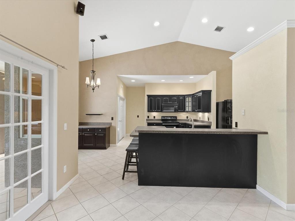 8551 Pratt Drive New Port Richey, FL 34654 - Photo 25 of 100 a kitchen with kitchen island a sink stainless steel appliances and cabinets