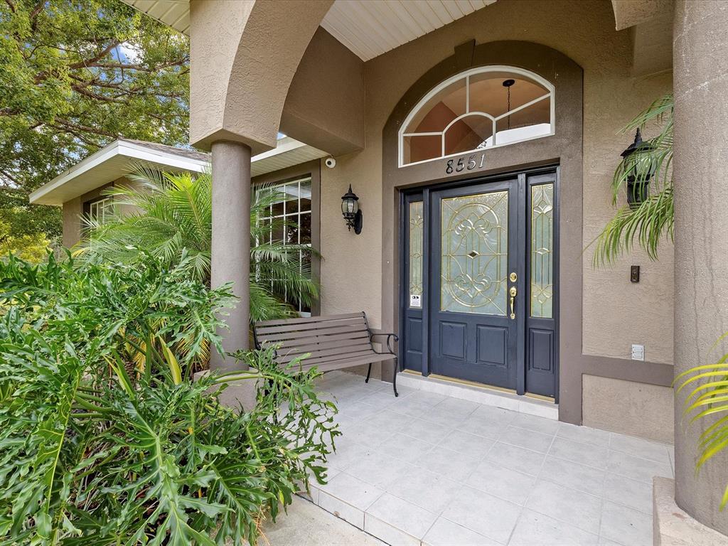 8551 Pratt Drive New Port Richey, FL 34654 - Photo 3 of 100 a front view of a house with a glass door