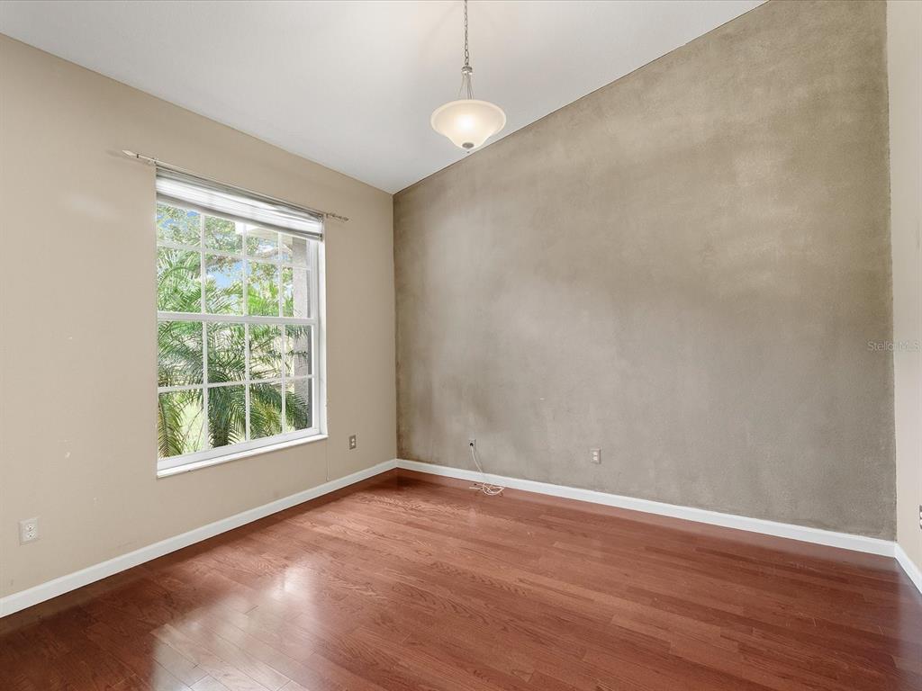 8551 Pratt Drive New Port Richey, FL 34654 - Photo 32 of 100 an empty room with wooden floor and windows