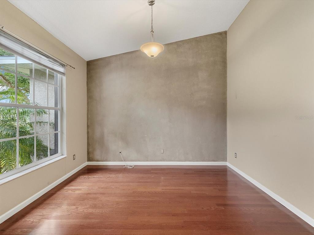 8551 Pratt Drive New Port Richey, FL 34654 - Photo 33 of 100 a view of a room with wooden floor and windows