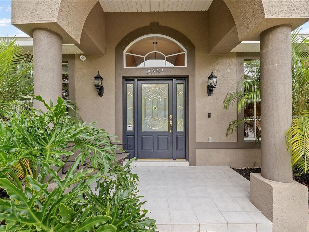 8551 Pratt Drive New Port Richey, FL 34654 - Photo 4 of 100 a front view of a house with a glass door