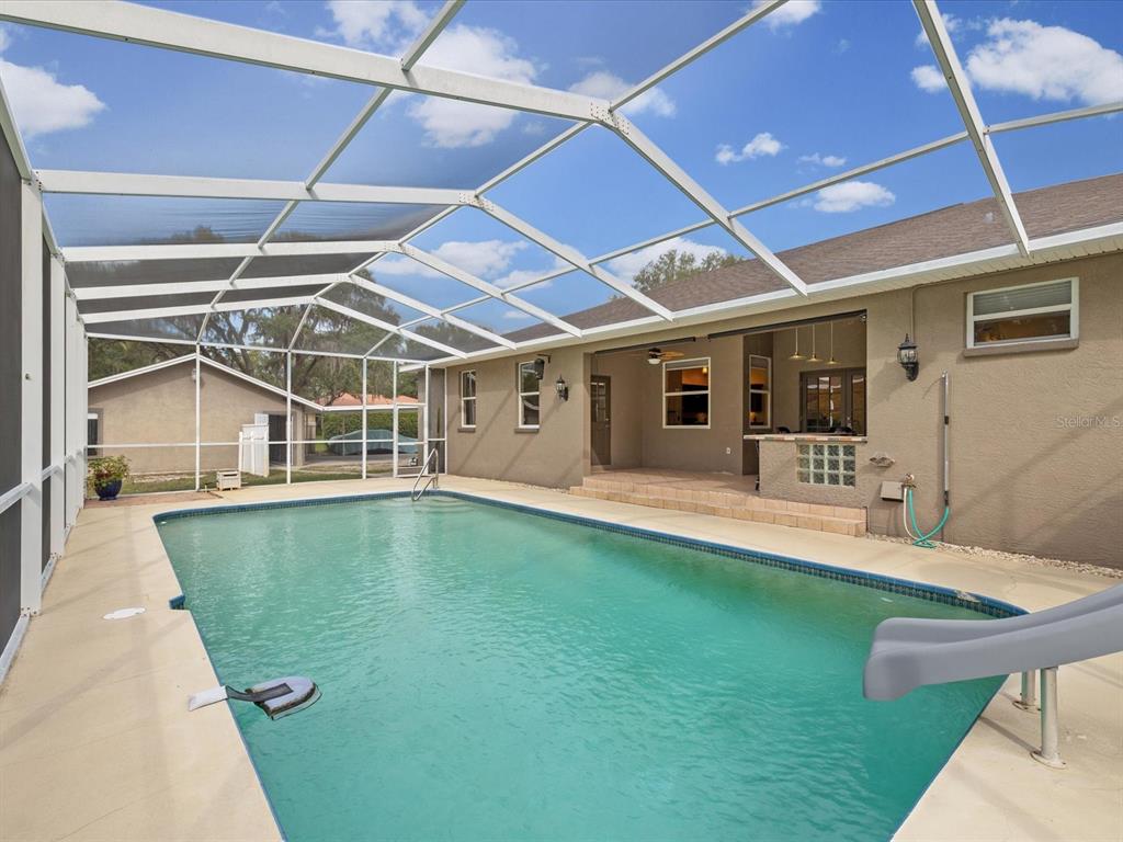 8551 Pratt Drive New Port Richey, FL 34654 - Photo 46 of 100 a view of a backyard with pool table and chairs
