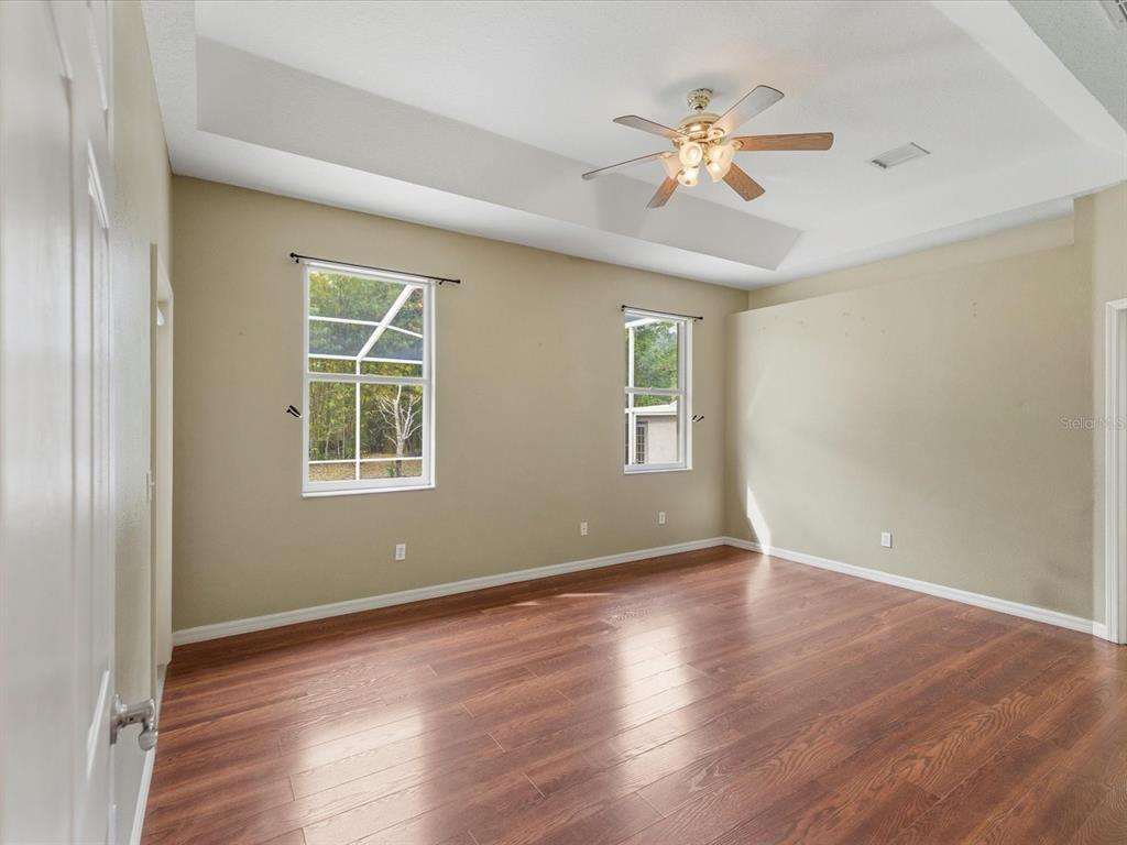 8551 Pratt Drive New Port Richey, FL 34654 - Photo 57 of 100 a view of an empty room with wooden floor and a window