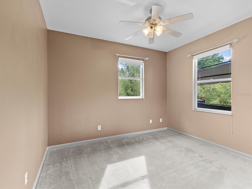 8551 Pratt Drive New Port Richey, FL 34654 - Photo 60 of 100 an empty room with windows and fan