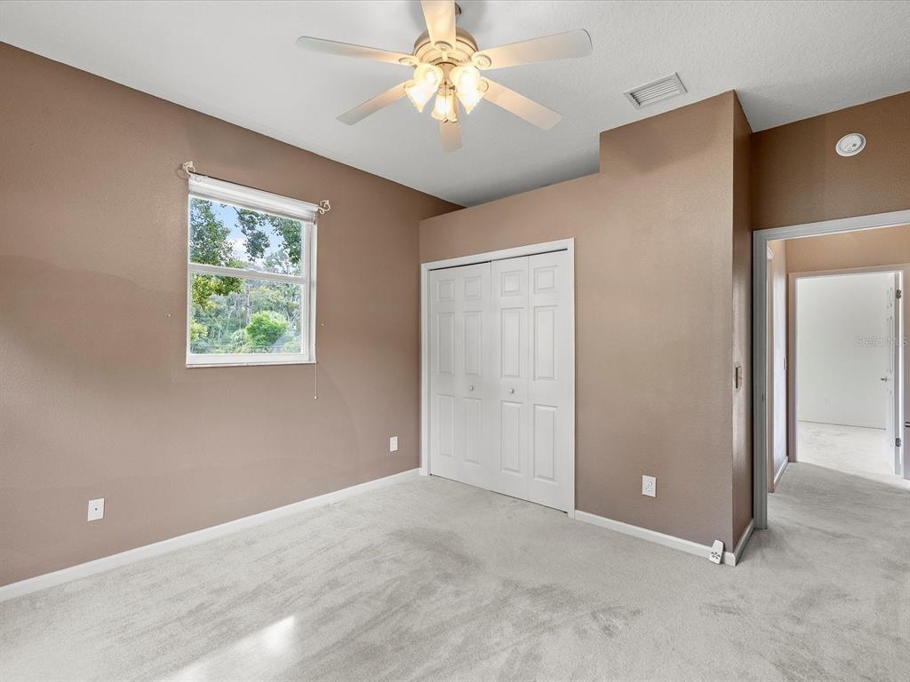 8551 Pratt Drive New Port Richey, FL 34654 - Photo 61 of 100 a view of an empty room with window and chandelier fan