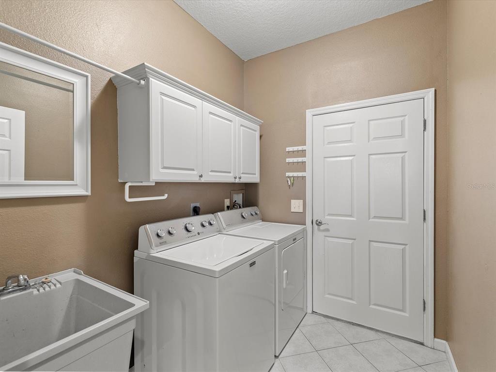 8551 Pratt Drive New Port Richey, FL 34654 - Photo 62 of 100 a utility room with a sink dryer and washer