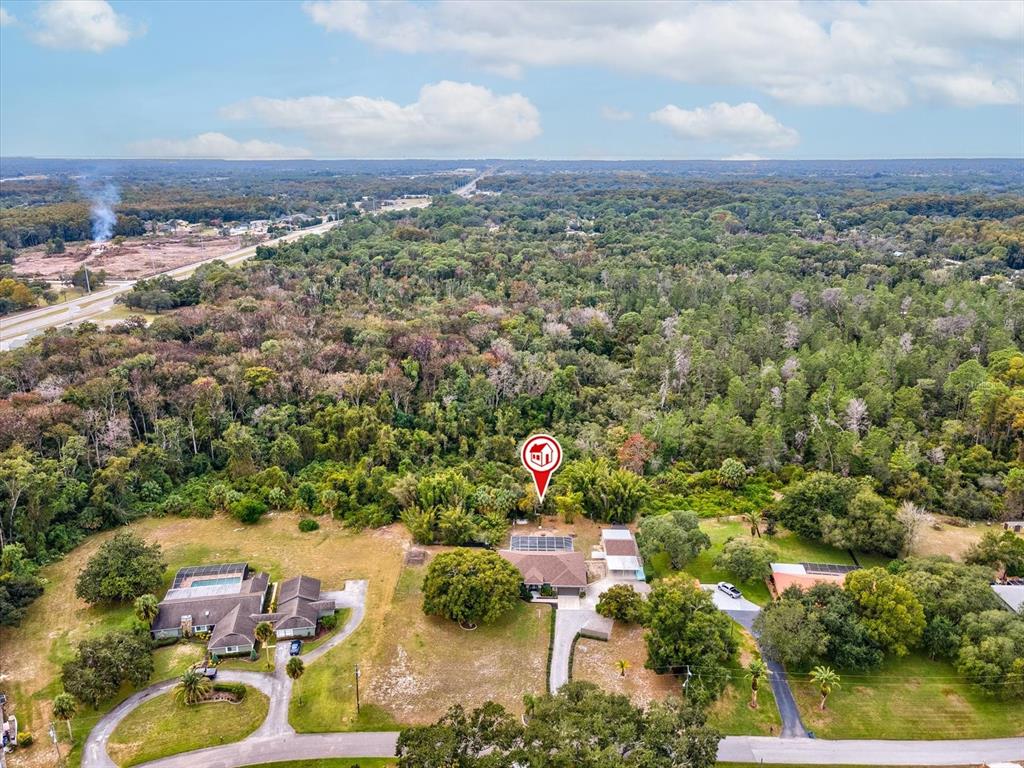 8551 Pratt Drive New Port Richey, FL 34654 - Photo 88 of 100 an aerial view of a residential houses with outdoor space and trees