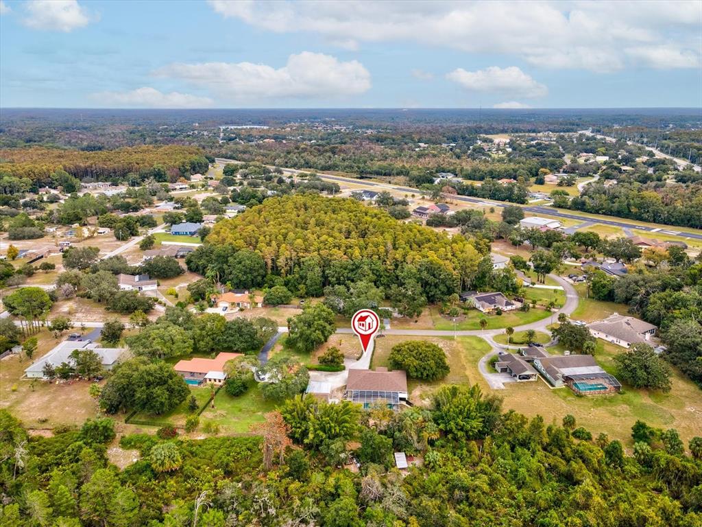 8551 Pratt Drive New Port Richey, FL 34654 - Photo 91 of 100 an aerial view of residential houses with outdoor space and trees