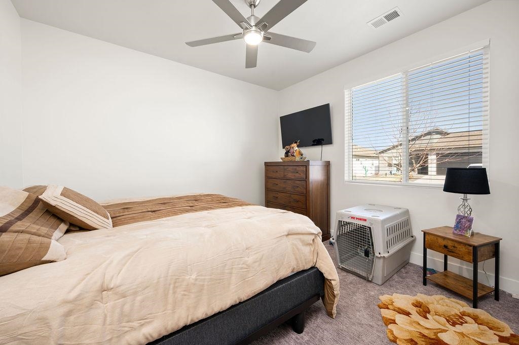 1694 Tungsten Way Fruita, CO 81521 - Photo 15 of 22 a bedroom with a bed and a flat screen tv
