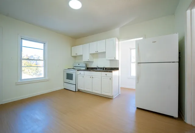 a kitchen with stainless steel appliances a refrigerator sink and cabinets