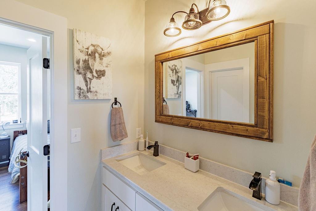 2094 Jim Harry Loop Sunset, TX 76270 - Photo 25 of 40 jack and jill bath on second floor with dual undermount sinks with shower and toilet separate