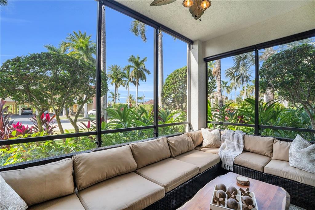 985 Sandpiper Street, Unit I103 Naples, FL 34102 - Photo 16 of 32 a balcony with furniture and a potted plant