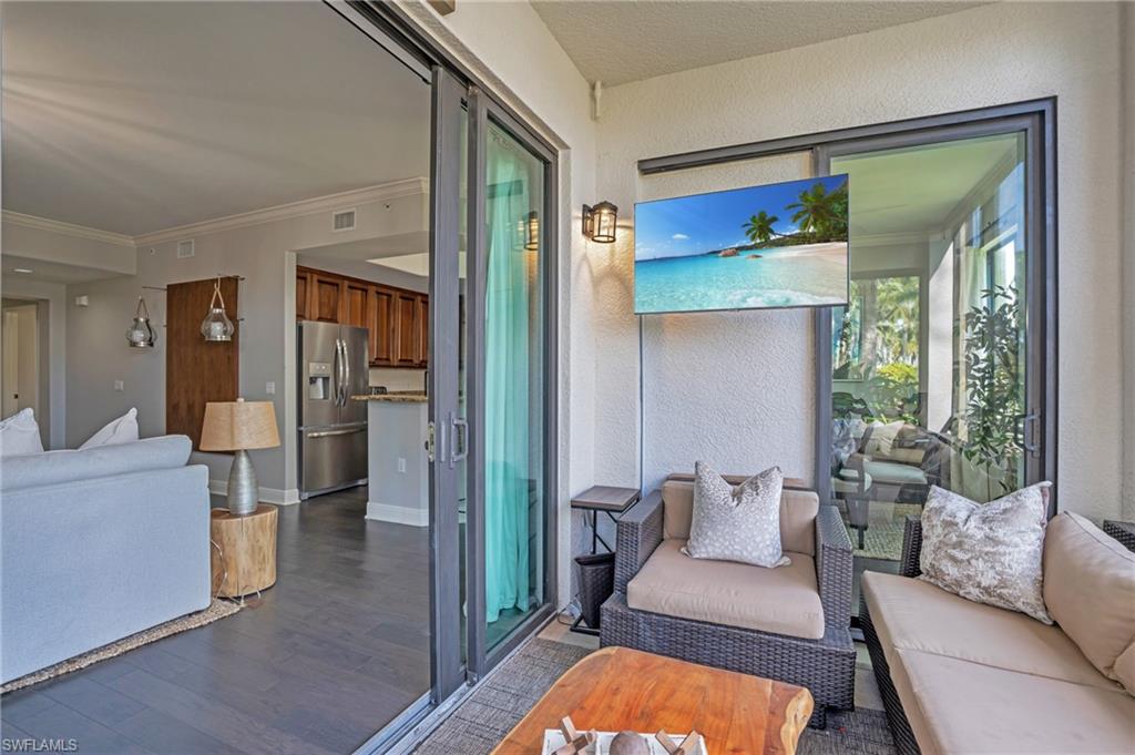 985 Sandpiper Street, Unit I103 Naples, FL 34102 - Photo 17 of 32 a living room with furniture and a large window