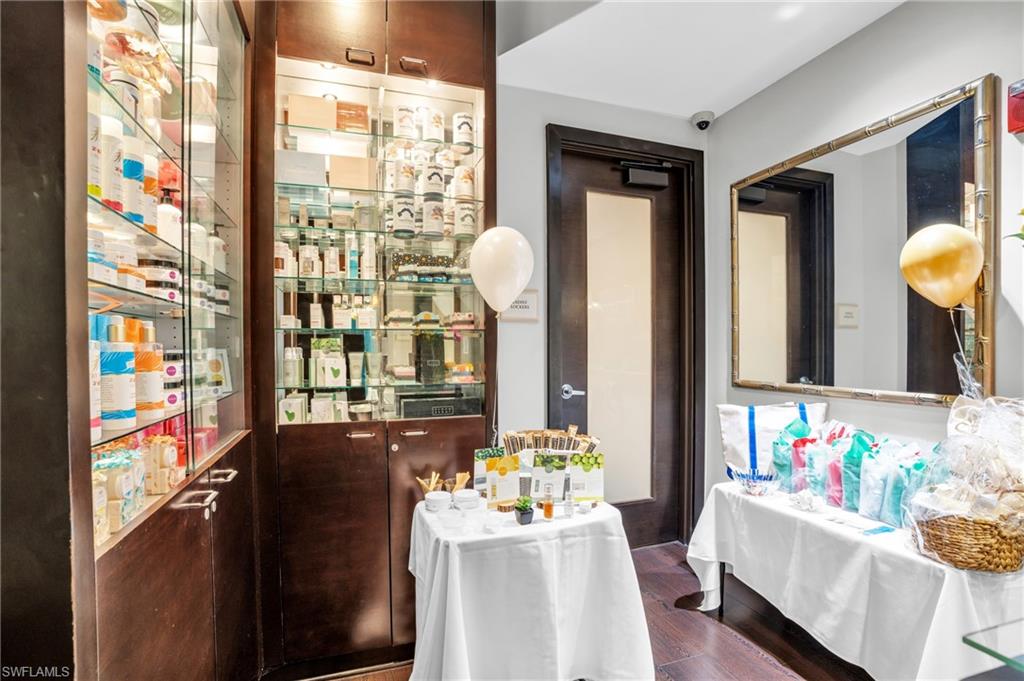 985 Sandpiper Street, Unit I103 Naples, FL 34102 - Photo 19 of 32 a living room filled with furniture and a floor to ceiling window