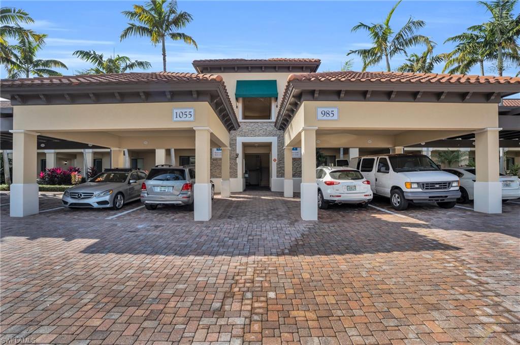 985 Sandpiper Street, Unit I103 Naples, FL 34102 - Photo 32 of 32 a view of a car parked in front of a building
