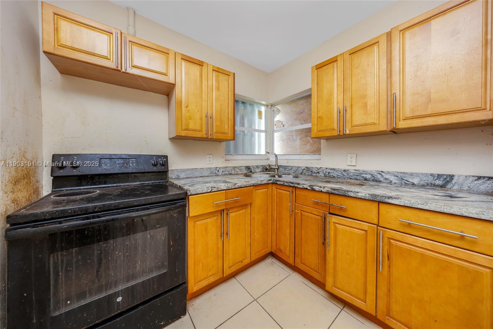 75 Northwest 83rd Street Miami, FL 33150 - Photo 12 of 47 a kitchen with granite countertop cabinets stainless steel appliances and a window