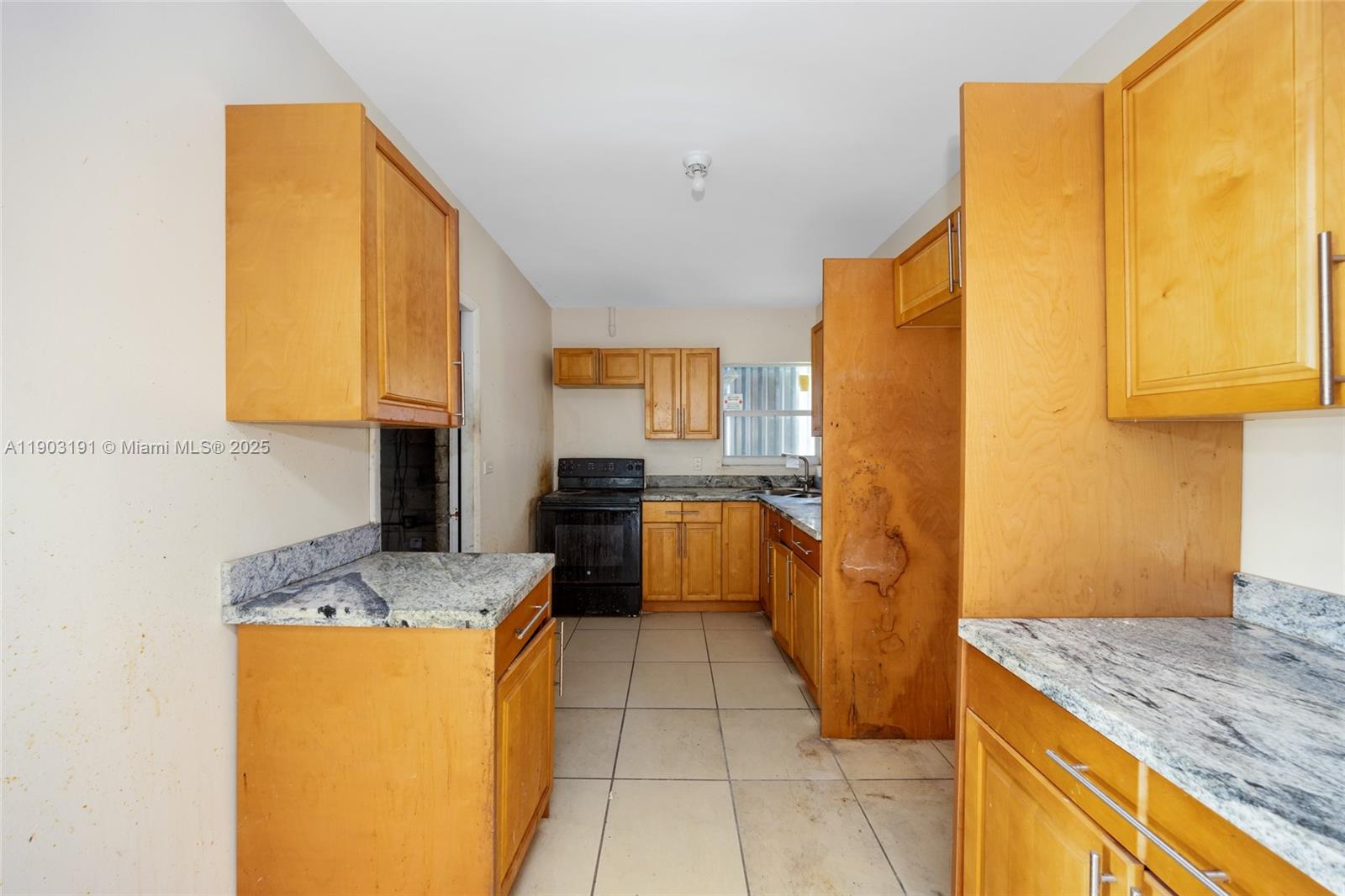 75 Northwest 83rd Street Miami, FL 33150 - Photo 13 of 47 a kitchen with stainless steel appliances granite countertop a sink counter space and a stove top oven