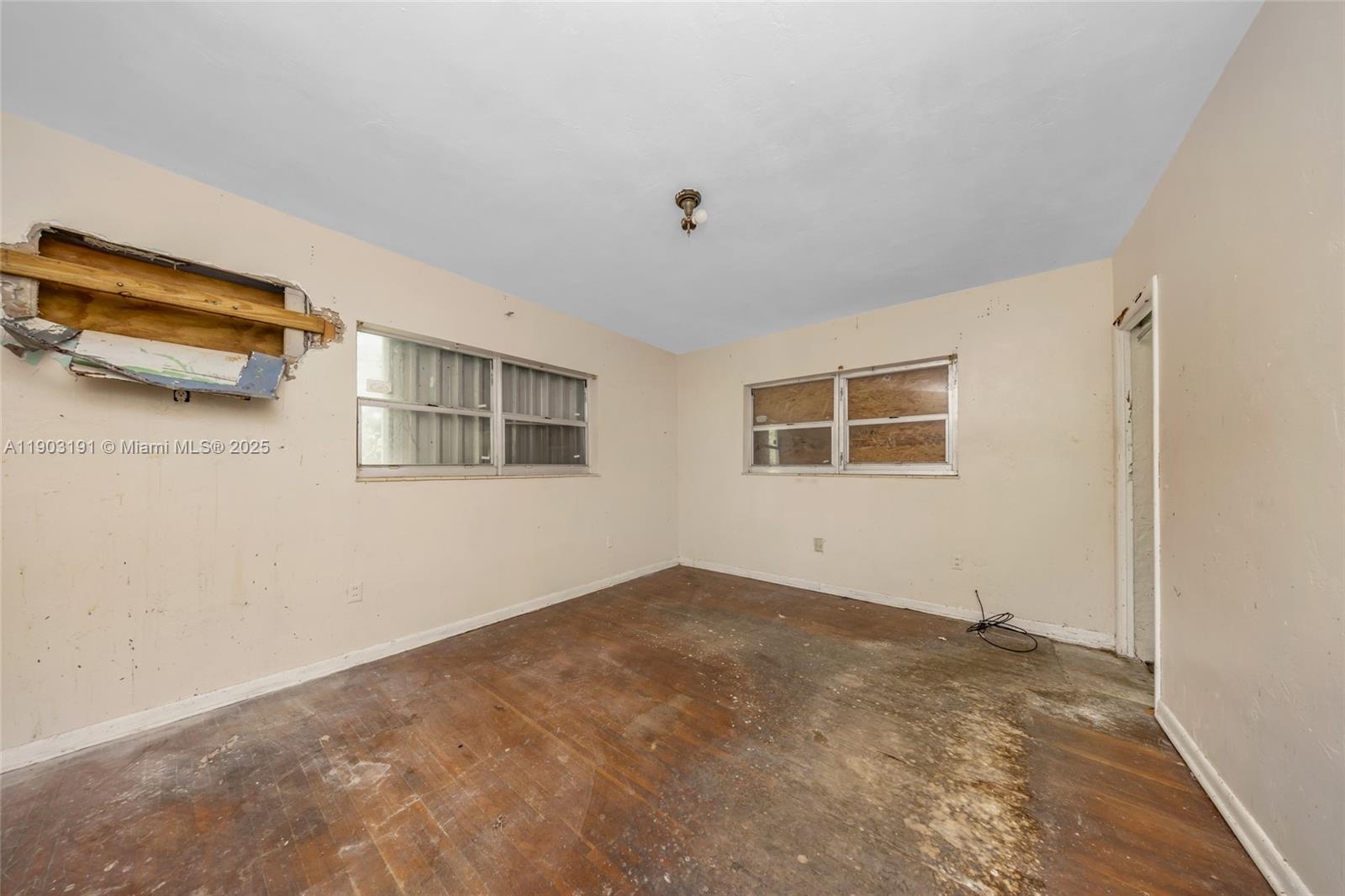 75 Northwest 83rd Street Miami, FL 33150 - Photo 22 of 47 a view of a livingroom with an empty space and a window