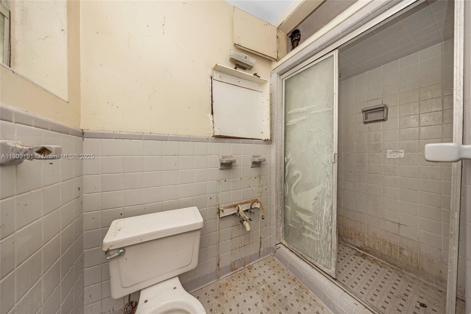 75 Northwest 83rd Street Miami, FL 33150 - Photo 23 of 47 a bathroom with a toilet and a shower