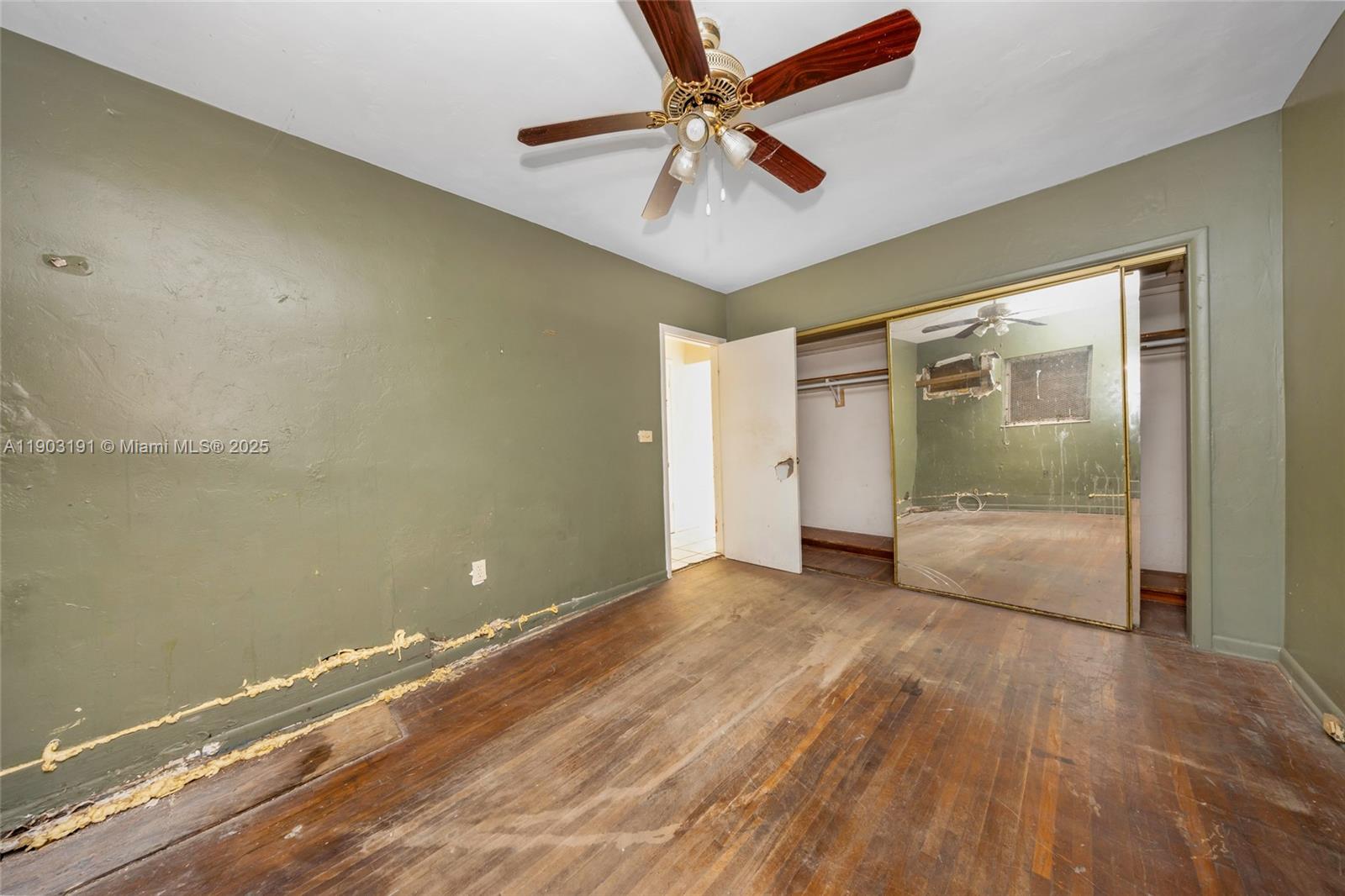 75 Northwest 83rd Street Miami, FL 33150 - Photo 24 of 47 an empty room with wooden floor and door