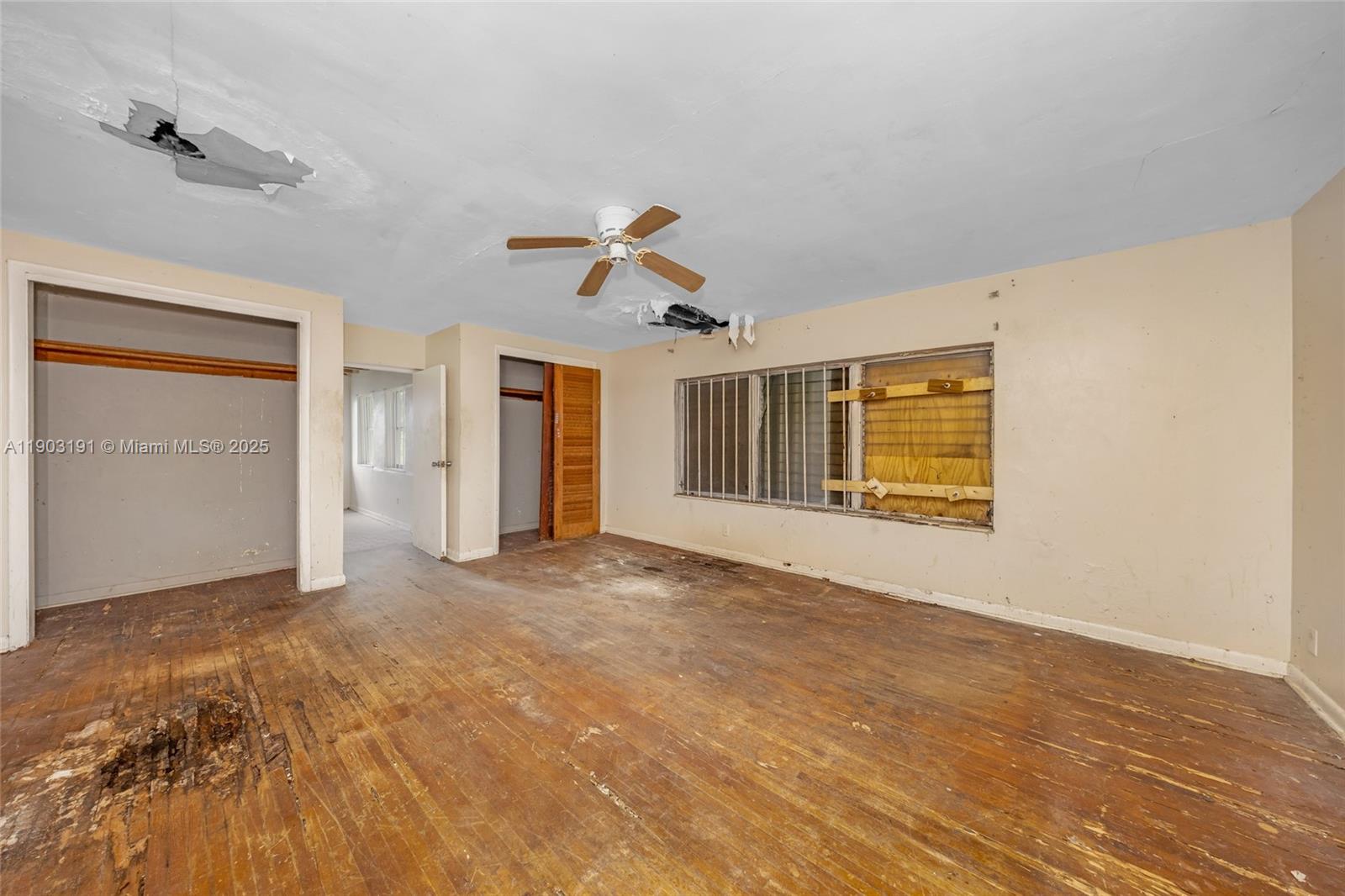 75 Northwest 83rd Street Miami, FL 33150 - Photo 28 of 47 a view of empty room with wooden floor and ceiling fan