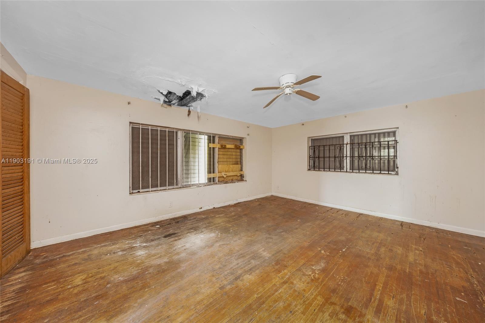 75 Northwest 83rd Street Miami, FL 33150 - Photo 29 of 47 a view of an empty room with a window and a ceiling fan