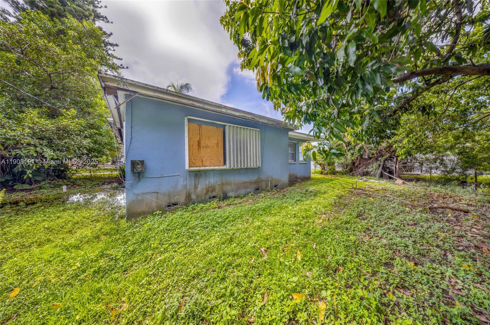 75 Northwest 83rd Street Miami, FL 33150 - Photo 34 of 47 a front view of a house with a yard