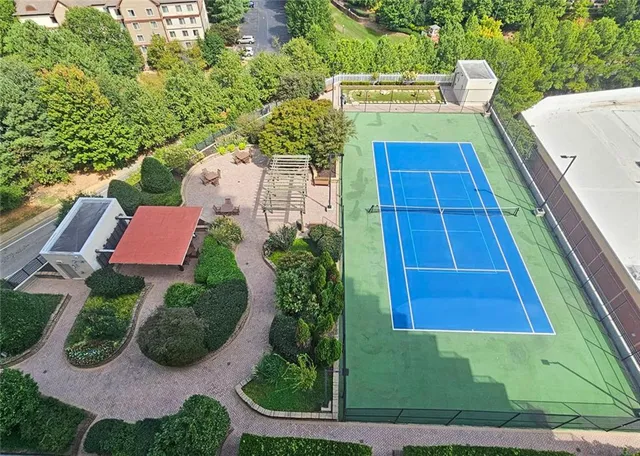 an aerial view of a house with swimming pool and garden