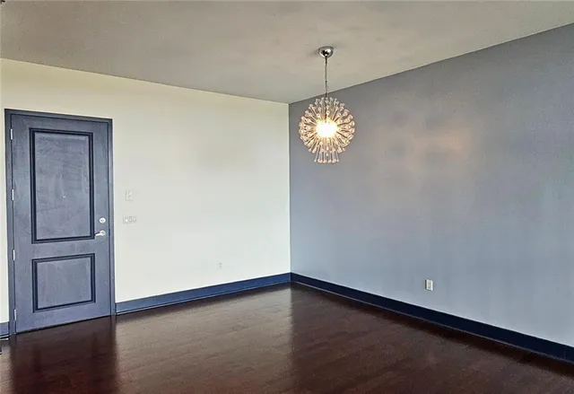 an empty room with wooden floor sink and closet