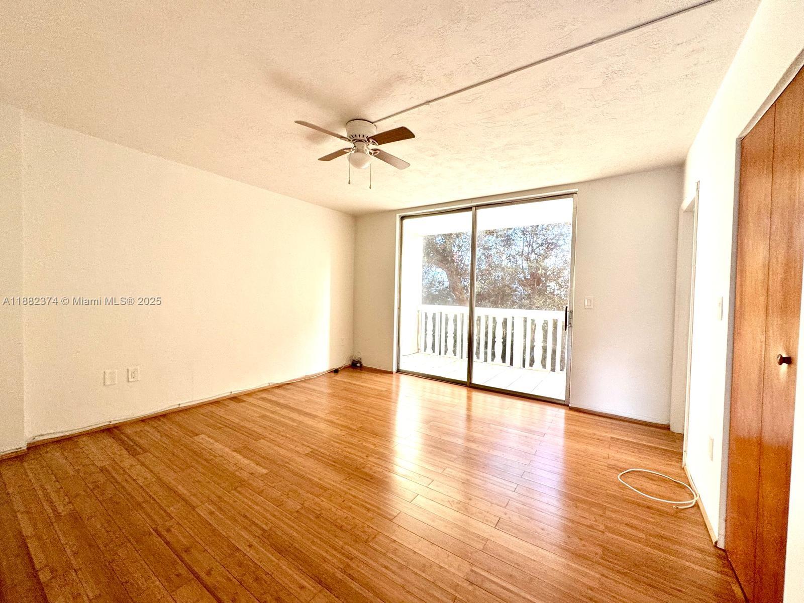 1475 Northeast 125th Terrace, Unit 404B North Miami, FL 33161 - Photo 1 of 22 a view of an empty room with a window and wooden floor