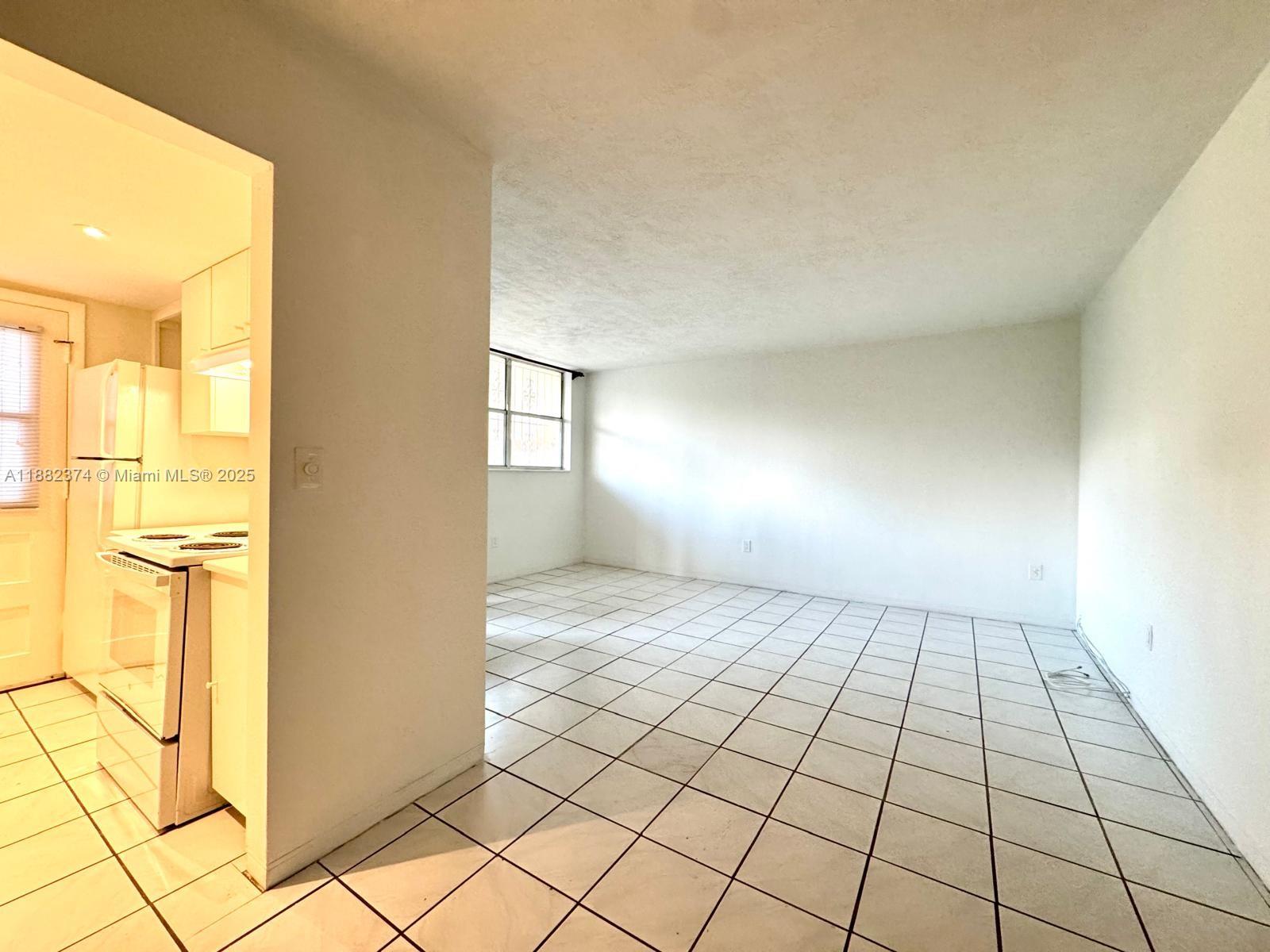 1475 Northeast 125th Terrace, Unit 404B North Miami, FL 33161 - Photo 11 of 22 a view of an empty room and window