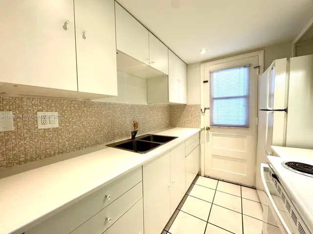a kitchen with a sink a stove and refrigerator