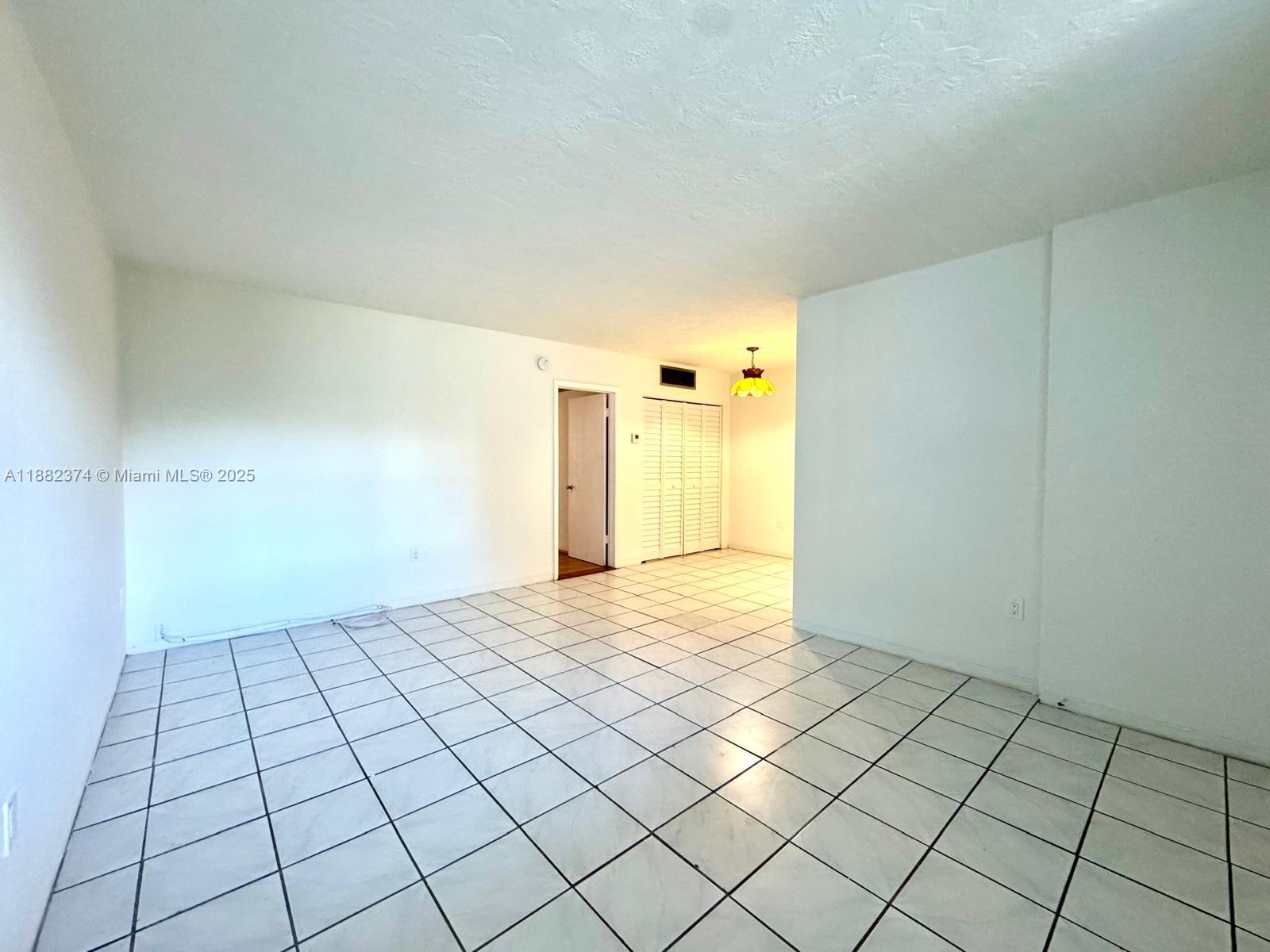 1475 Northeast 125th Terrace, Unit 404B North Miami, FL 33161 - Photo 15 of 22 a view of an empty room and window