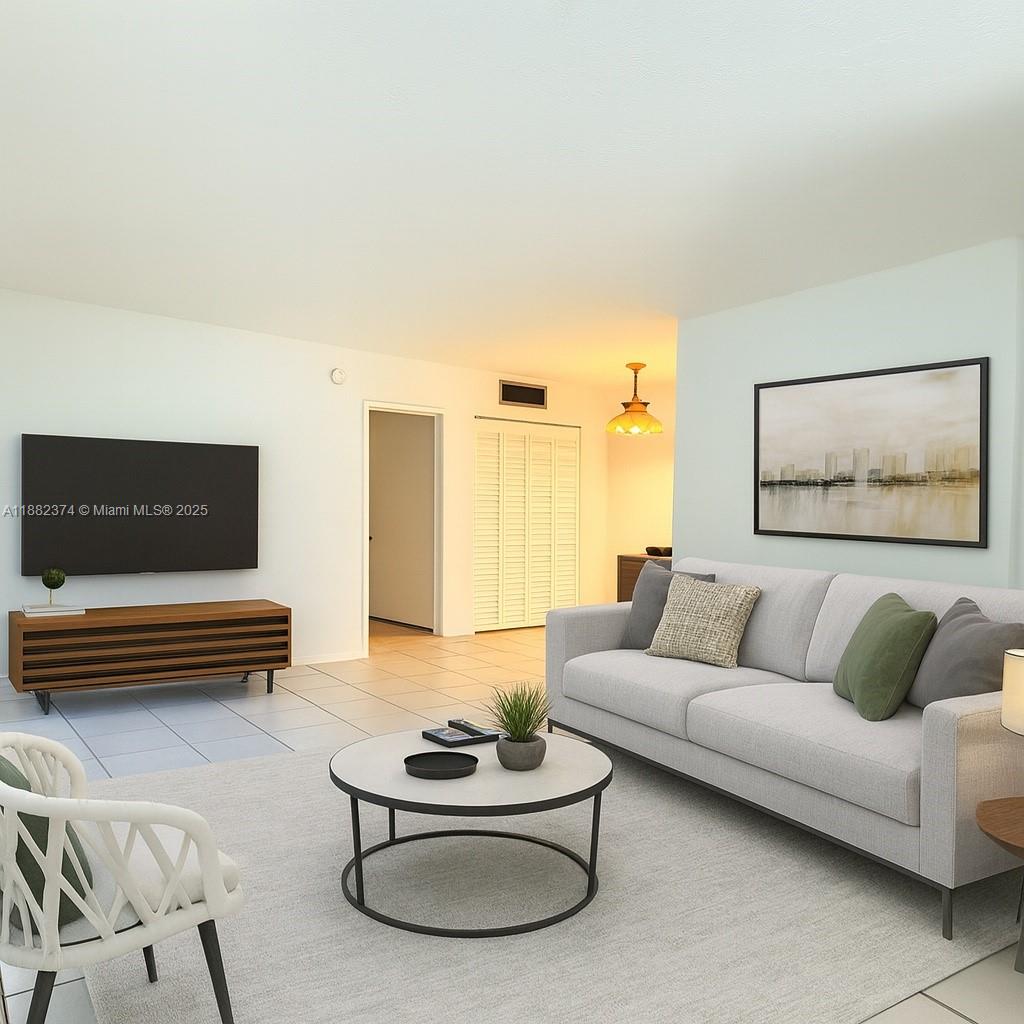 1475 Northeast 125th Terrace, Unit 404B North Miami, FL 33161 - Photo 16 of 22 a living room with furniture and a couch