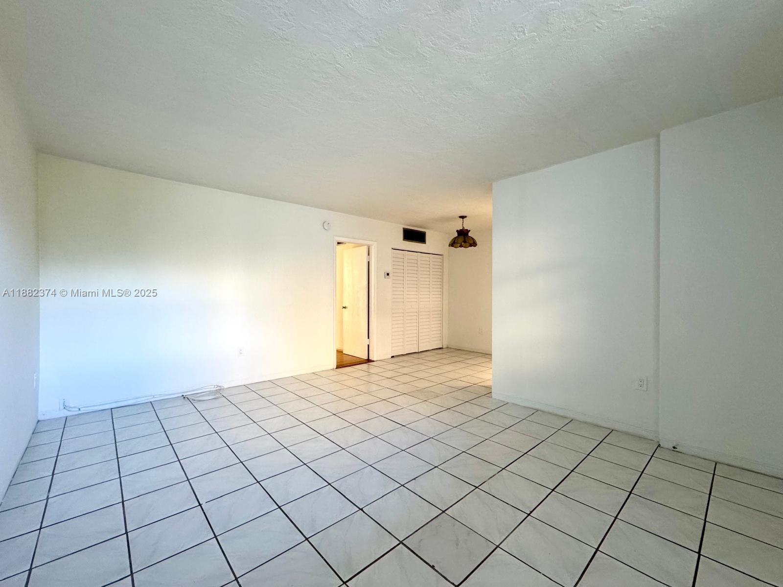 1475 Northeast 125th Terrace, Unit 404B North Miami, FL 33161 - Photo 18 of 22 a view of an empty room and window