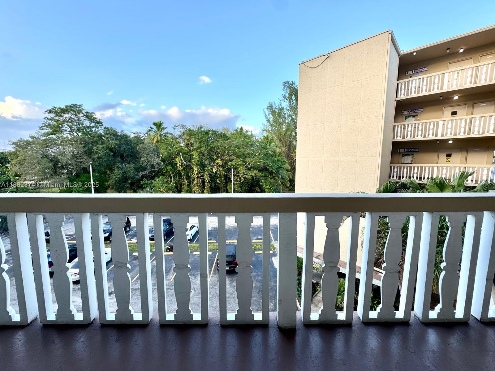 1475 Northeast 125th Terrace, Unit 404B North Miami, FL 33161 - Photo 20 of 22 a view of a chair and table in the roof deck