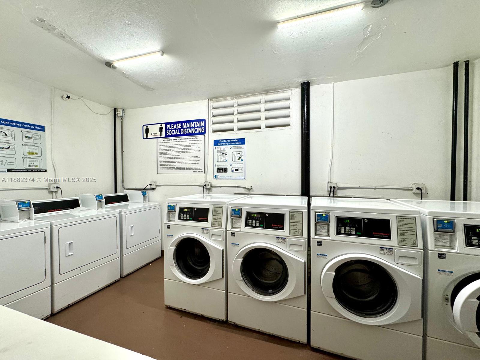 1475 Northeast 125th Terrace, Unit 404B North Miami, FL 33161 - Photo 21 of 22 a utility room with dryer and washer
