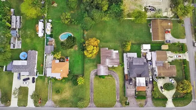 an aerial view of houses with yard