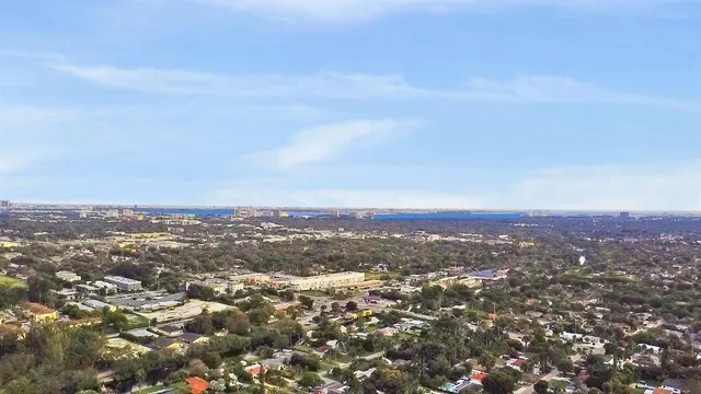 an aerial view of residential houses with city view