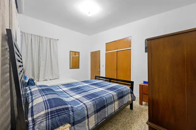 a bedroom with a bed and a closet