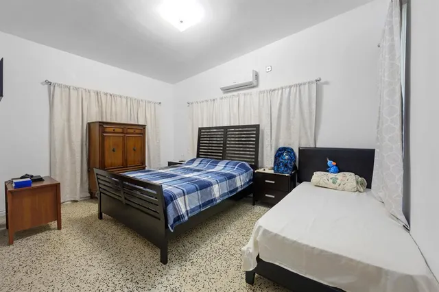 a bedroom with a bed and window