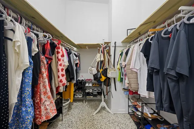 a view of walk in closet with clothes
